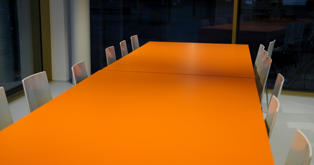 Empty boardroom table with chairs — implied responsibility on company directors