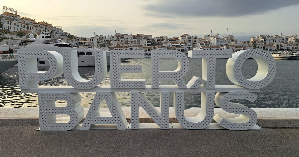 Iconic Puerto Banús sign at sunset, Marbella's luxury marina