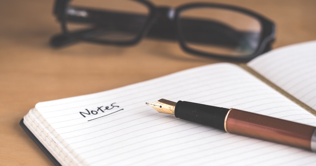 Brown fountain pen on an open notebook, classic estate-planning visual